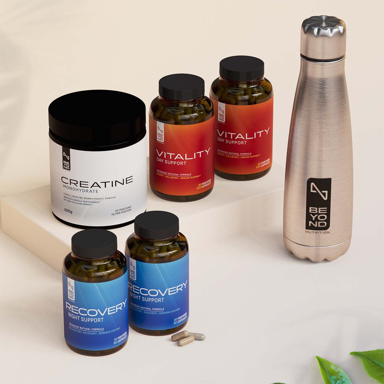 Supplement bottles and a metal water bottle on a light background