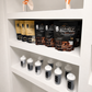 Shelf display of Beyond Nutrition Whey Protein powder bags and shaker bottles in a clean white indoor setting.