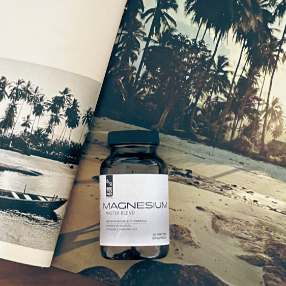 Bottle of magnesium supplement from Beyond Nutrition on a magazine with palm tree images