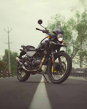 Motorcycle on a road with trees in the background