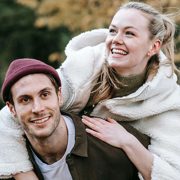 Man and woman in winter clothing smiling outdoors