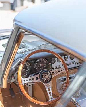 Close-up of a classic car's steering wheel and dashboard